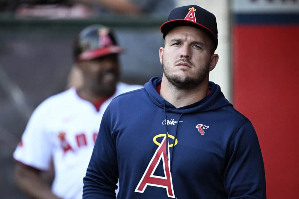 ANAHEIM, CALIFORNIA - AUGUST 01: Mike Trout #27 of the Los Angeles Angels looks on from the dugout during the first inning against the Colorado Rockies at Angel Stadium of Anaheim on August 01, 2024 in Anaheim, California.
